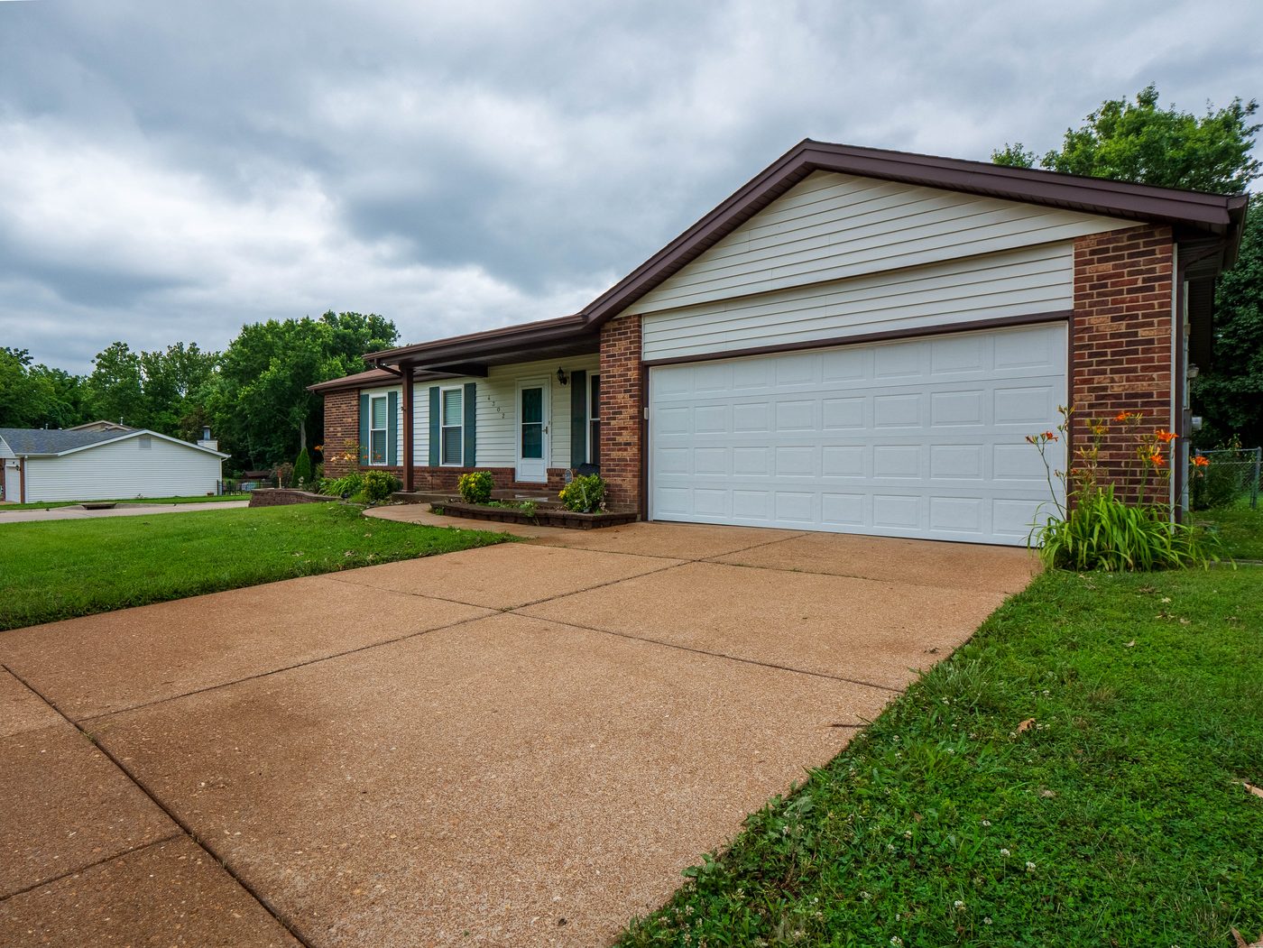Property exterior and driveway after professional pressure washing, South County St. Louis
