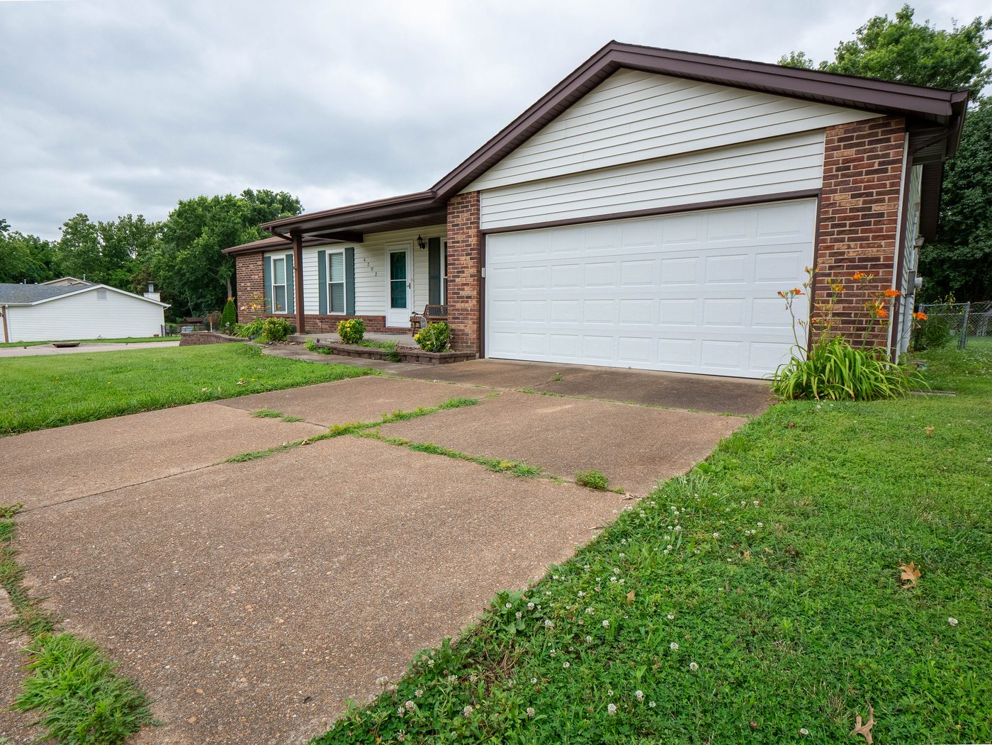 Property exterior and driveway before professional pressure washing, South County St. Louis