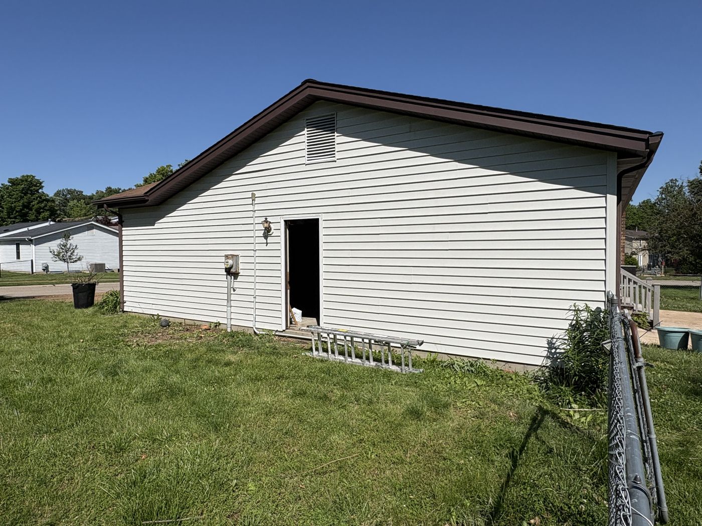 Vinyl siding after soft washing, clean white finish